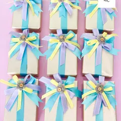 The final touch can make all the difference. These gifts are wrapped and adorned with a multi-layered bow in pastel colors, demonstrating how I use high-quality materials to create a beautiful presentation.