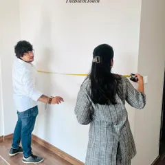 Taking precise measurements of a room. This foundational step is crucial for our "what you see is what you get" promise, as it ensures all custom furniture and fittings will be a perfect fit.