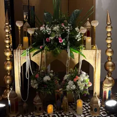 A lavish and romantic setup for a 10th wedding anniversary. We used ornate golden lanterns, pearl strings, and beautiful floral arrangements to create a magical, Arabian nights inspired corner.