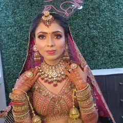 A classic bridal portrait. This look features bold eyes, a defined contour, and rich lip color, all framed by a beautiful dupatta. I ensure the makeup complements the heavy jewellery and intricate outfit.