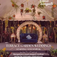 An evening wedding setup in the Terrace Garden, starting from just ₹70K. The space features a beautiful floral arch and hanging plants.