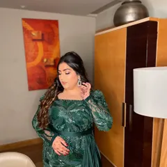 A glam goddess in this green ensemble. This look is perfect for a cocktail party or reception, featuring a dramatic eye, contoured features, and beautiful wavy hair.