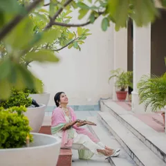 The bride showing off her beautiful Mehendi. Her upward gaze and happy expression capture the excitement and anticipation of the wedding.