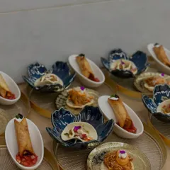 A platter of assorted Mexican appetizers from our 7-course dinner, including crunchy avocado tacos, pulled jackfruit tostadas, and black bean taquitos.