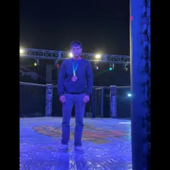 A champion stands alone in the octagon after a hard-fought victory at Elite Combat MMA in Ajmer, a testament to individual dedication and team support.