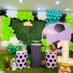 Another view of the football birthday decor, showing the arrangement of props like bird cages and the custom marquee number.