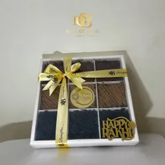 My Rakhi brownie box, beautifully packaged with a golden ribbon and a "Happy Rakhi" tag, making it a complete and elegant gift.