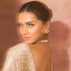 The captivating Tara Sutaria, embodying grace and elegance in our delicate Polki and pearl choker set. A vision in white.