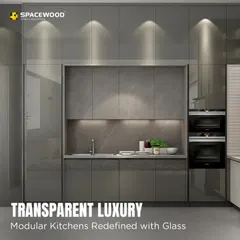 I use glass cabinetry to add a touch of transparent luxury and make a kitchen feel more open. This design features high-gloss grey cabinets with smoked glass doors and internal lighting, perfect for showcasing your finest glassware while maintaining a clean, modern look.