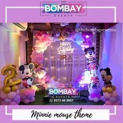 A classic that never goes out of style! This Minnie and Mickey Mouse theme for a 2nd birthday uses a beautiful pastel and purple color palette, with a circular balloon arch and character cutouts.