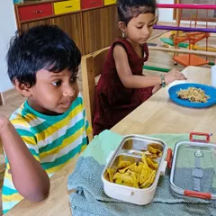 Children enjoying their healthy snacks together. Sharing food and conversation during meal times helps build social skills.