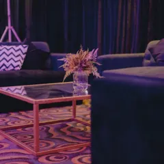A shot of the lounge area during setup, showing the placement of furniture and decor details before the party begins.