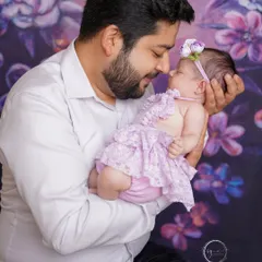 A father's loving gaze. This tender moment between dad and his newborn daughter is a memory to be cherished forever.