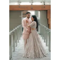 A tender moment during an engagement shoot at the event venue. The groom's gentle touch and their focused expressions create a quiet, romantic portrait amidst the celebration.