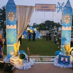 The grand entrance arch designed to look like the gates of a winter castle. Complete with faux snow, snowflake details, and a shimmering curtain, it made every guest feel like they were entering a magical kingdom.