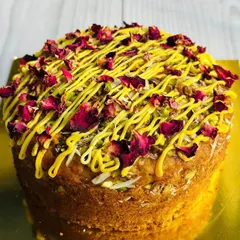 Celebrate Holi or any festival with my special Thandaai tea cake. This moist cake is infused with traditional Thandaai spices and topped with pistachios, almonds, and dried rose petals.