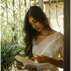 A lifestyle-inspired shot of the model reading by a window. This adds a narrative element to the series, making it feel more personal.