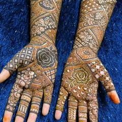 A close-up of the palms for a full-coverage bridal design. The patterns are a beautiful mix of floral and geometric motifs.