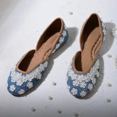 The Emma Blue Vegan Jutti is like a garden for your feet. Adorned with delicate 3D organza flowers, these denim-blue juttis are perfect for adding a fresh, whimsical touch to your daytime outfits.