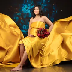A seated pose with the yellow fabric artfully arranged, creating a beautiful and dynamic composition that feels both regal and full of life.