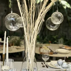 A closer look at the details from our workshop tablescape. Hanging glass orbs, tall taper candles, and scattered pearls on the table create layers of texture and light, showing how to build a truly luxurious and multi-dimensional setting.