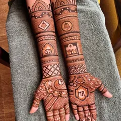 A full-arm engagement design with personalized initials. I can weave your story into the mehandi with custom elements like names, dates, or symbols that are special to you.
