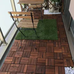 Here, I've used a mix of materials to add texture and design to the balcony floor. The majority of the space is covered in rich wooden deck tiles, with a small artificial grass patch to place the bistro set on.