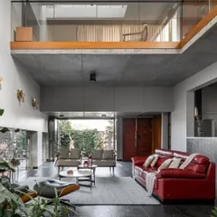 The mezzanine level overlooks the main living area, creating a visual connection between the private family space above and the social hub below. This open, layered design makes the home feel connected and spacious.