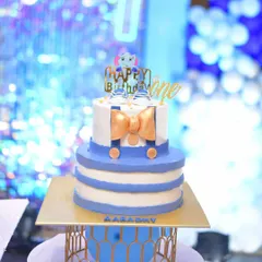 A cute cake for a first birthday, designed with a little shirt and bow tie theme.