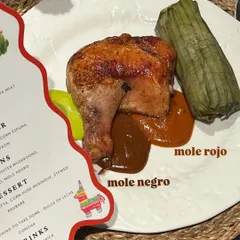 Our main course for the Mexican dinner: roasted chicken with two kinds of mole, mole rojo and mole negro, served alongside a traditional tamale.