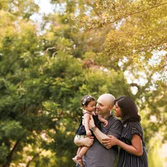 A beautiful story of family love, captured under the warm glow of the sun in a lush green park. Outdoor sessions provide a stunning natural backdrop for family portraits.