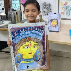 The pure joy of a finished masterpiece! Here is one of our youngest students, Naomika, proudly showing off her vibrant Durga Ma watercolor painting. We love seeing these happy smiles at the end of a class.