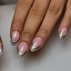 A glamorous take on the French manicure. This design features a cat-eye glitter base for the tips, outlined with a sharp, elegant chrome line for a truly luxurious feel.