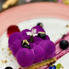 A feast for the eyes and the palate. This Unbaked Blueberry Cheesecake features a vibrant, cloud-like mousse on a crisp biscuit base, showcasing a modern approach to dessert presentation.