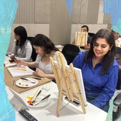 Smiles and focus during a corporate painting event. I provide all the supplies and guidance, making it easy for everyone to participate, regardless of their artistic experience.