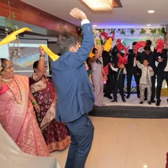 Leading the charge on the dance floor. Sometimes the best way to break the ice is with some music and a simple, fun group dance activity.