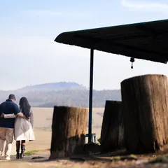Walking away together towards the horizon. This shot from their destination pre-wedding session captures a feeling of journey and shared adventure against a beautiful, open landscape.