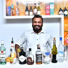A smile from behind the bar at a house party. We bring a wide selection of spirits like Hendrick's, Jack Daniel's, and Absolut to create a full-service bar for any private celebration.