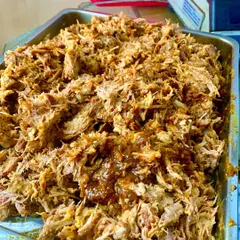 A generous tray of our signature Pulled Pork, slow-cooked for eight hours until it's perfectly tender. We then toss it in a rich, tangy tomato and BBQ reduction made from its own flavorful juices.