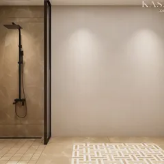 This minimalist bathroom design focuses on clean lines and subtle textures. The floor features an intricate mosaic tile rug pattern, adding a decorative element without overwhelming the serene, marble-effect porcelain tile surroundings.