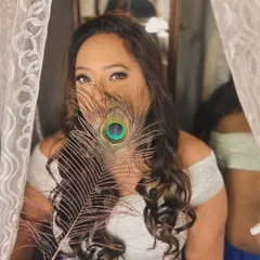 Another beautiful and creative portrait. The eye makeup is the focus here, peeking through the peacock feather for an intriguing effect.