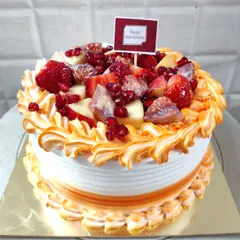 A beautiful fresh fruit anniversary cake. This one is loaded with strawberries, figs, apples, and pomegranate seeds.