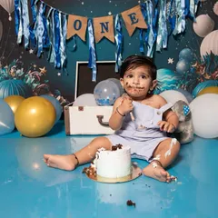 A cake smash session is all about capturing pure, unfiltered joy. This little one had the best time exploring his first birthday cake, and his messy, happy face is a perfect memory of this sweet milestone.