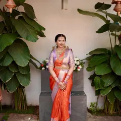 A full view of the engagement ensemble, showcasing the elegant drape of the silk saree against a backdrop of lush greenery. This is a look crafted for the bride who desires elegance with a modern flair.