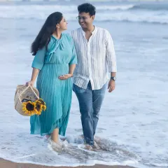 A gentle stroll along the shore during the magical golden hour. This beach maternity session captures the relaxed and joyful connection between the couple, with a basket of sunflowers adding a perfect pop of color.