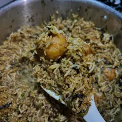 A spoonful of my homemade Aloo Dum Biryani. The basmati rice is layered with baby potatoes cooked in a fragrant masala and slow-cooked in its own steam.