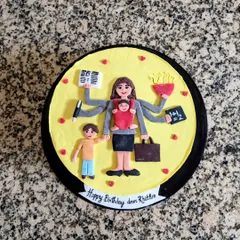 A tribute to all the supermoms out there. This fondant topper for a cake shows a multitasking mom, juggling work, kids, and home, all handcrafted with care.
