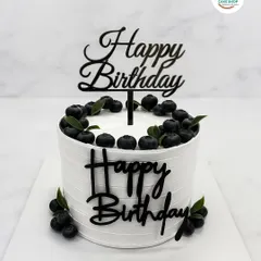 A clean and elegant design for a sophisticated birthday celebration. This cake features a textured white buttercream finish, topped with fresh blueberries and a personalized acrylic topper for a modern and stylish look.