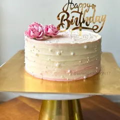 Sweet simplicity at its best. This pineapple buttercream cake features a textured finish, edible pearls, and delicate pink flowers for a classic look.