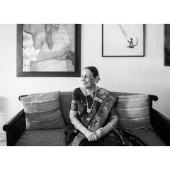 This black and white candid shot captures a moment of quiet reflection. It’s an authentic, unposed image that speaks volumes, showing her gentle smile and the peaceful atmosphere of her home.